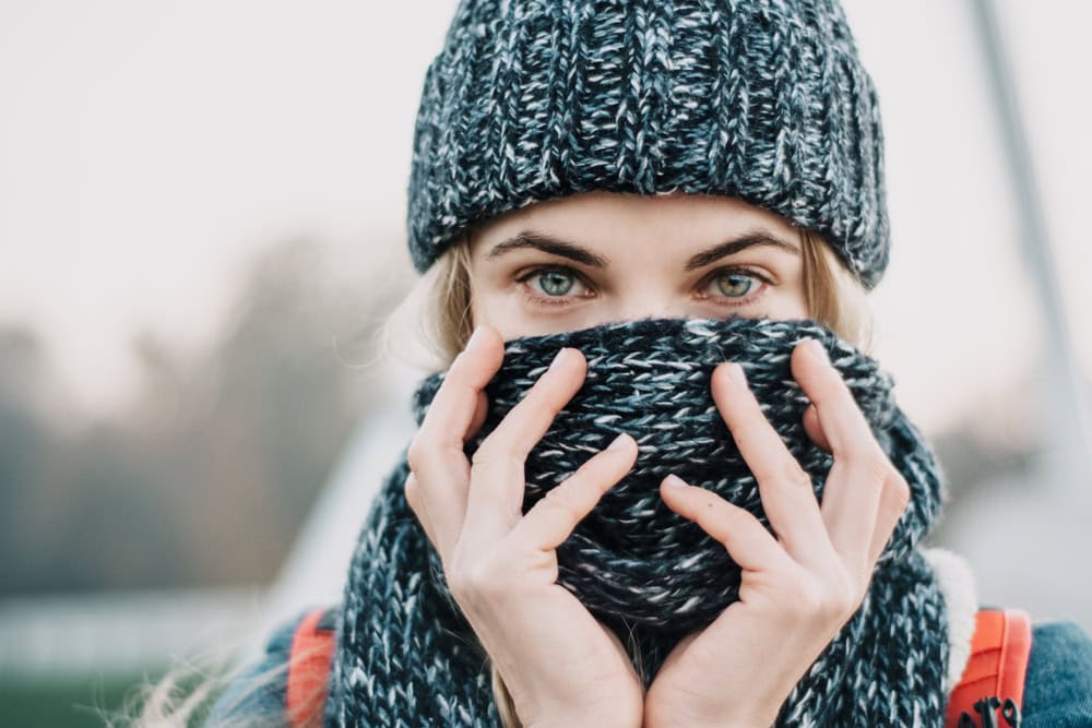 Portrait,Of,Young,Blonde,Woman,Closing,Face,With,Winter,Scarf.