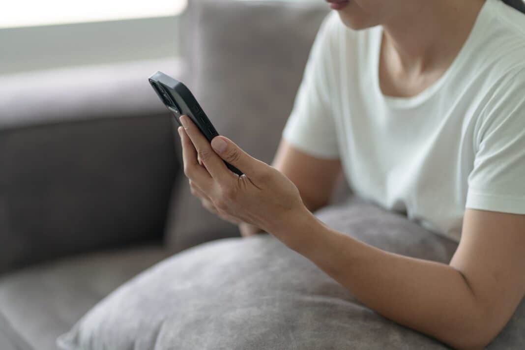 Woman,Hand,Using,Smartphone,For,Checking,Social,Media,Or,Woman