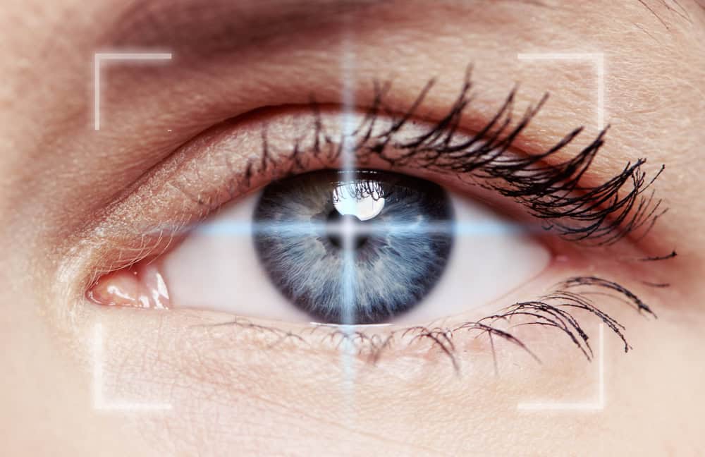 Macro,Shot,Of,Human,Blue,Eye,With,Laser,Rays,.